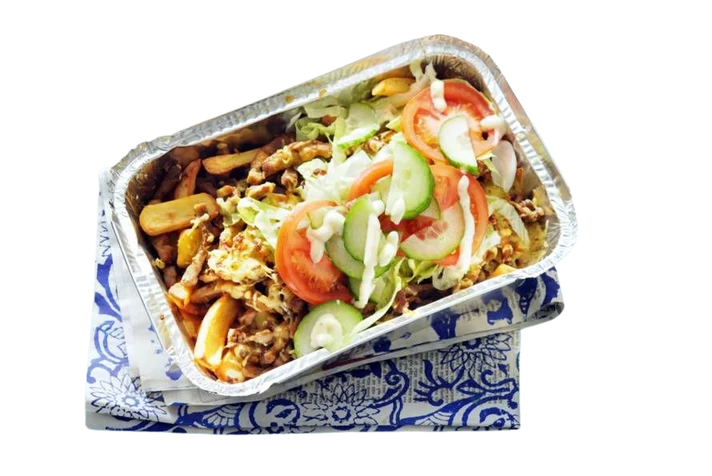 Chicken Kapsalon in a foil tray with fries, chicken, cheese, salad and white sauce