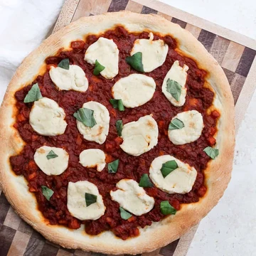Pizza Bolognese with a rich red sauce, mozzarella and basil