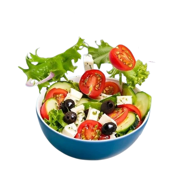 Fresh salad tossed above a blue bowl
